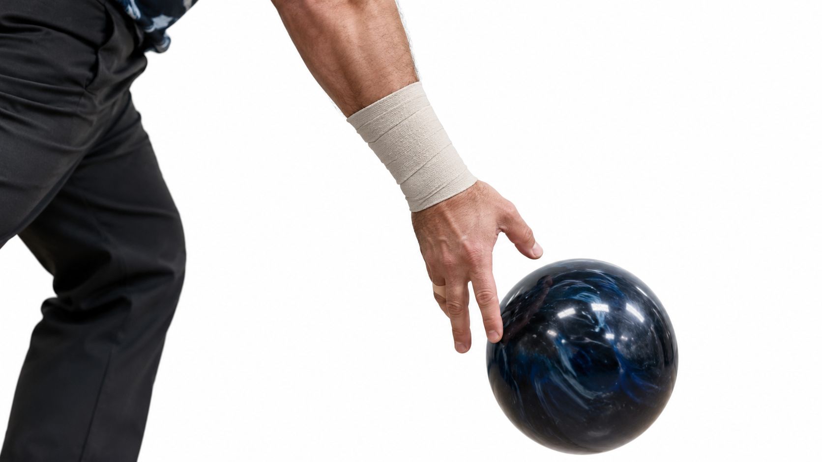 A close-up view of a bowler with beige wrist support tape on their forearm holding a ball.